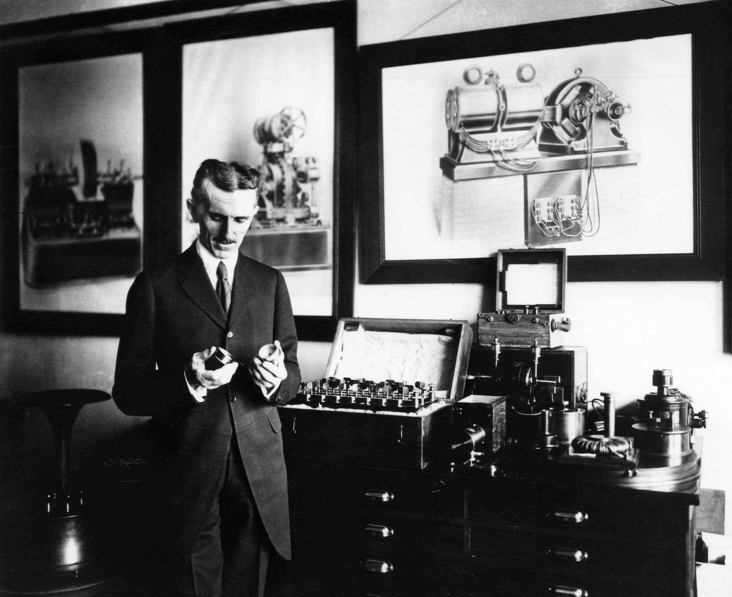 Nikola Tesla examining equipment in his New York laboratory